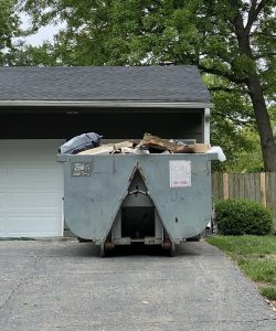 Dumpster rental placed on a St. Marys driveway for seasonal decluttering