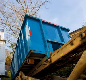mini bin rental being loaded onto driveway